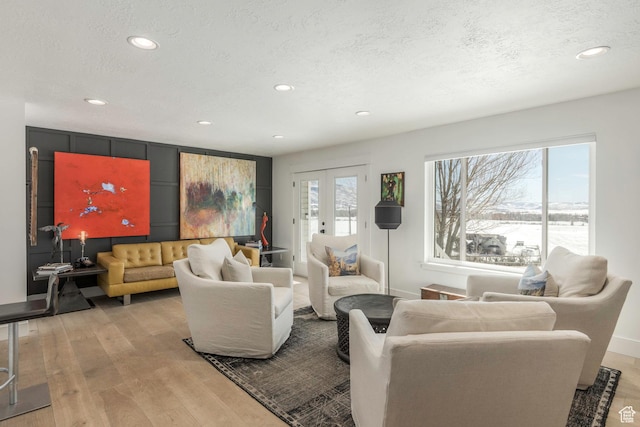 528 W Weber Canyon Rd, Oakley, UT 84055 - living room featuring recessed lighting, light wood-style floors, french doors, a textured ceiling, and baseboards