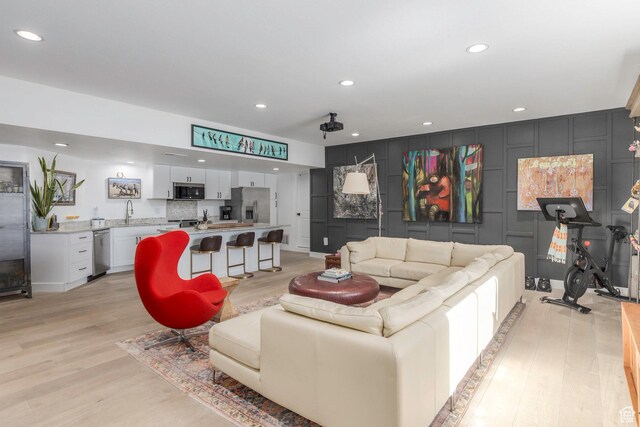 528 W Weber Canyon Rd, Oakley, UT 84055 - living room featuring light wood-style floors, recessed lighting, and a decorative wall