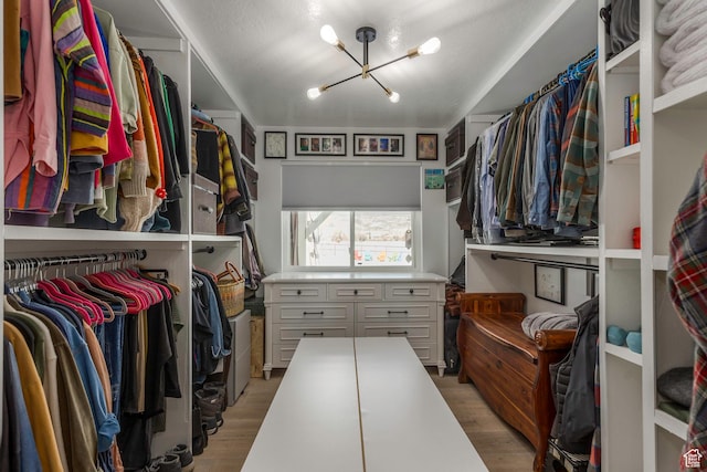 528 W Weber Canyon Rd, Oakley, UT 84055 - spacious closet with a chandelier and light wood-style flooring