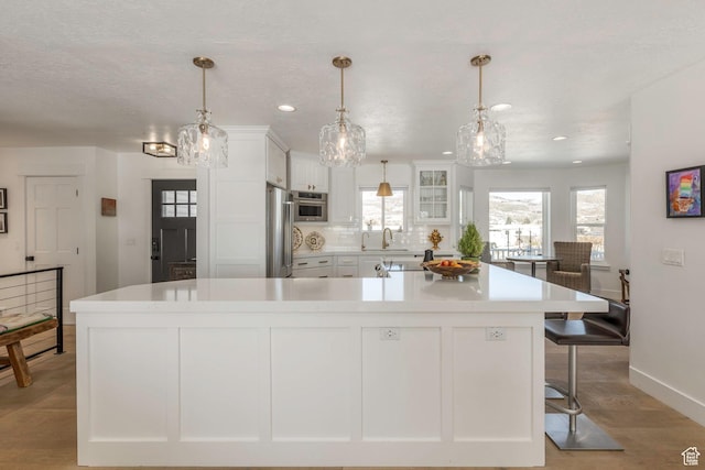 528 W Weber Canyon Rd, Oakley, UT 84055 - kitchen with a sink, white cabinets, light countertops, high end refrigerator, and recessed lighting