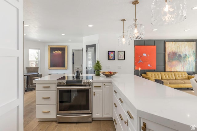 528 W Weber Canyon Rd, Oakley, UT 84055 - kitchen featuring stainless steel range with electric cooktop, light countertops, white cabinetry, recessed lighting, and a chandelier