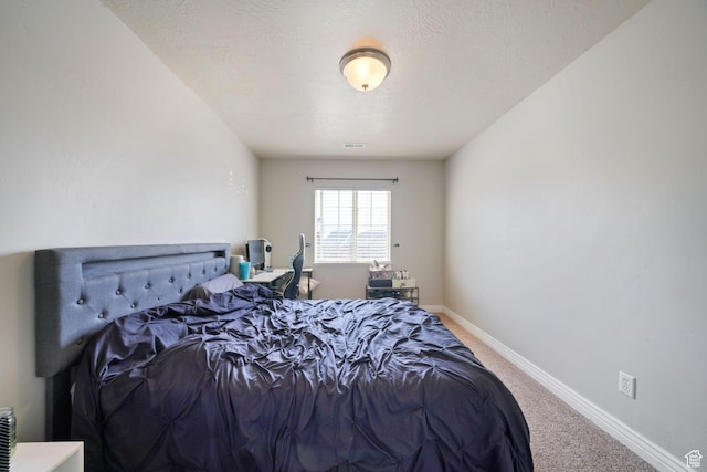 bedroom featuring baseboards and carpet floors