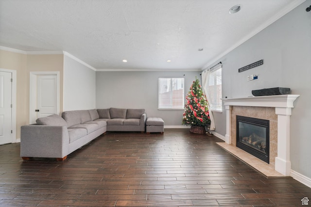 living area featuring baseboards, a fireplace, crown molding, recessed lighting, and dark wood-type flooring