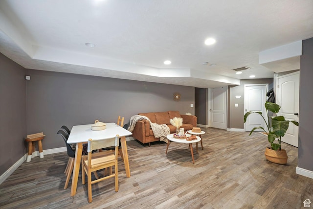 dining area featuring wood finished floors, baseboards, and visible vents