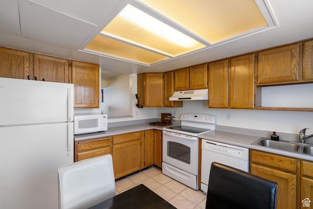 430 N 470 W Unit 14, Lehi, UT 84043 - kitchen with white appliances, brown cabinetry, under cabinet range hood, light tile patterned flooring, and a sink