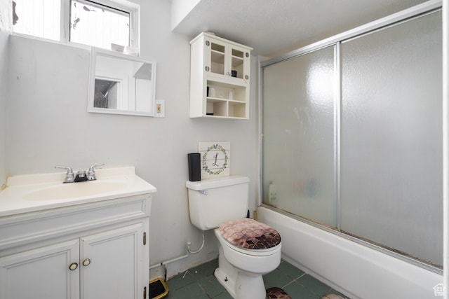1604 Childs Ave, Ogden, UT 84404 - full bathroom with tile patterned flooring, toilet, combined bath / shower with glass door, and vanity