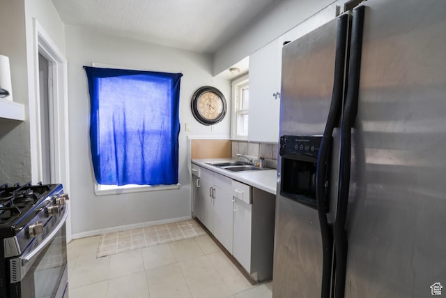 1604 Childs Ave, Ogden, UT 84404 - kitchen with a sink, light tile patterned floors, light countertops, and appliances with stainless steel finishes