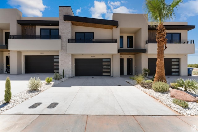 5266 W 2480 S Unit 149, Hurricane, UT 84737 - view of front of home featuring a garage, driveway, stucco siding, and a balcony
