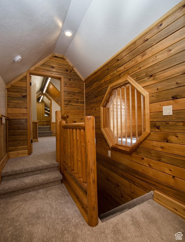 3804 E 2050 N, Eden, UT 84310 - staircase with carpet flooring, wooden walls, a textured ceiling, and vaulted ceiling