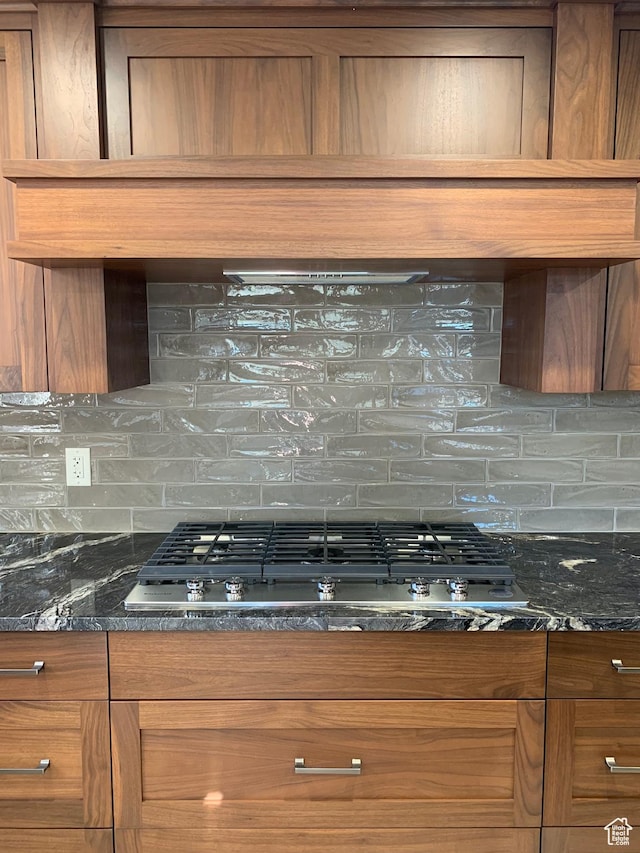 3804 E 2050 N, Eden, UT 84310 - kitchen featuring brown cabinetry, tasteful backsplash, stainless steel gas stovetop, and dark stone countertops