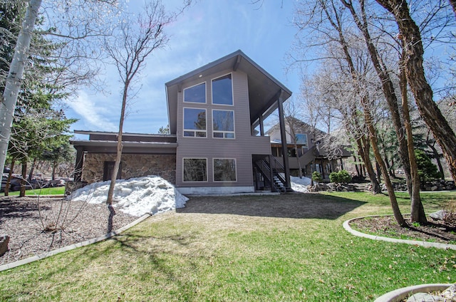 3804 E 2050 N, Eden, UT 84310 - back of house featuring stairs, stone siding, and a lawn