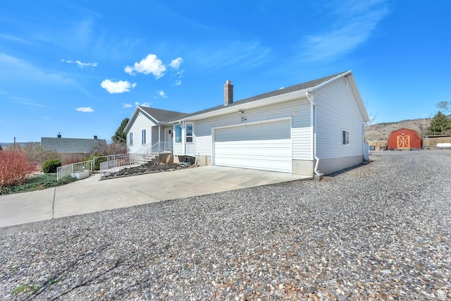 154 W Main St, Bicknell, UT 84715 - view of front facade with an attached garage, driveway, and a chimney