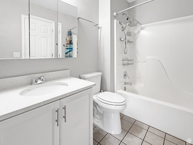 bathroom featuring toilet, tile patterned floors, bathtub / shower combination, and vanity