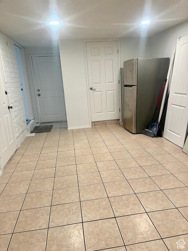 kitchen featuring light tile patterned floors and freestanding refrigerator