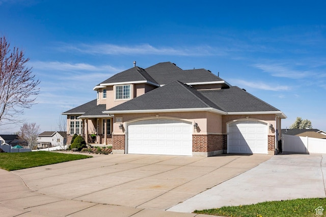 2115 N 5 E, Layton, UT 84041 - view of front of home featuring concrete driveway, an attached garage, stucco siding, brick siding, and a shingled roof