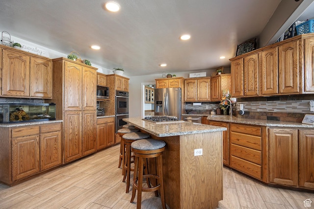 2115 N 5 E, Layton, UT 84041 - kitchen with stainless steel appliances, a center island, backsplash, brown cabinets, and recessed lighting