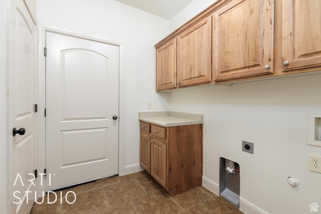 laundry room with baseboards, cabinet space, and electric dryer hookup
