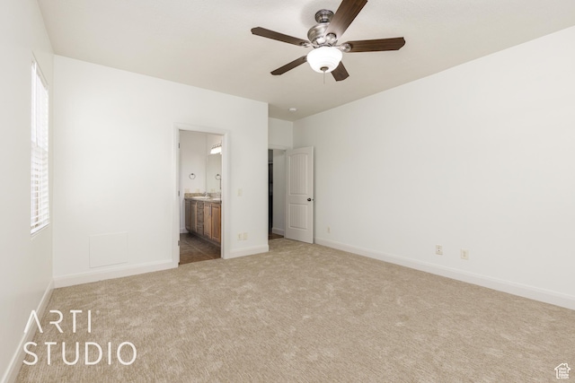 unfurnished bedroom featuring baseboards, ceiling fan, connected bathroom, and carpet flooring
