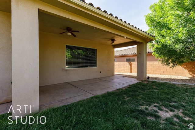 view of patio featuring fence and ceiling fan