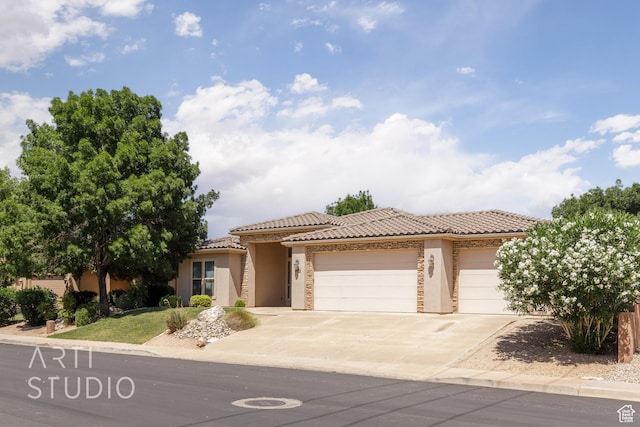 1971 S Great Basin Dr, Washington, UT 84780 - mediterranean / spanish-style home with stucco siding, a garage, a tile roof, and driveway