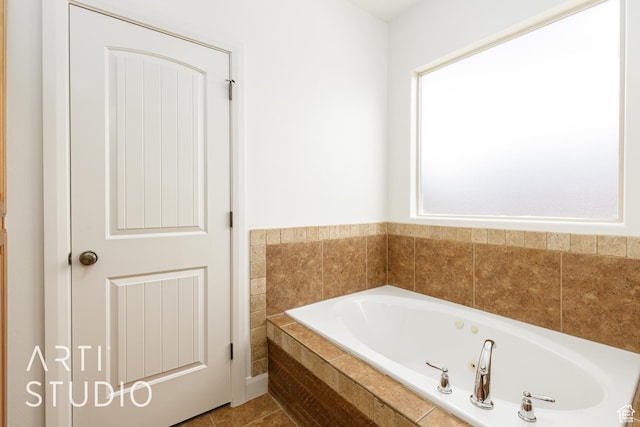 full bath featuring a jetted tub and tile patterned floors