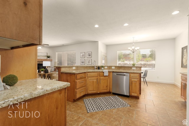 1971 S Great Basin Dr, Washington, UT 84780 - kitchen with stainless steel dishwasher, recessed lighting, a fireplace, a chandelier, and light stone counters