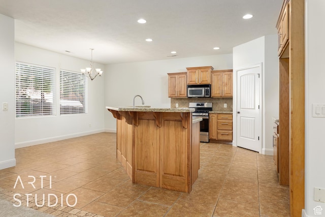 kitchen featuring recessed lighting, a chandelier, decorative backsplash, a breakfast bar area, and appliances with stainless steel finishes