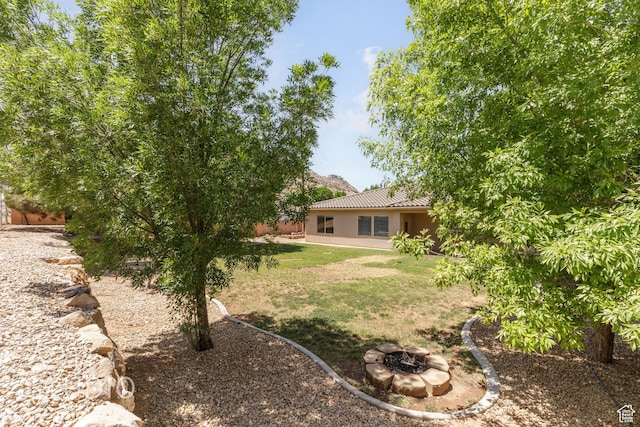 1971 S Great Basin Dr, Washington, UT 84780 - view of green lawn with an outdoor fire pit