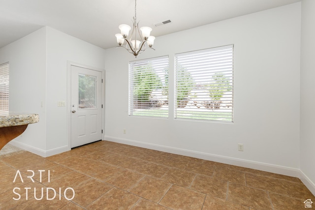 unfurnished dining area with light tile patterned floors, visible vents, a chandelier, and baseboards
