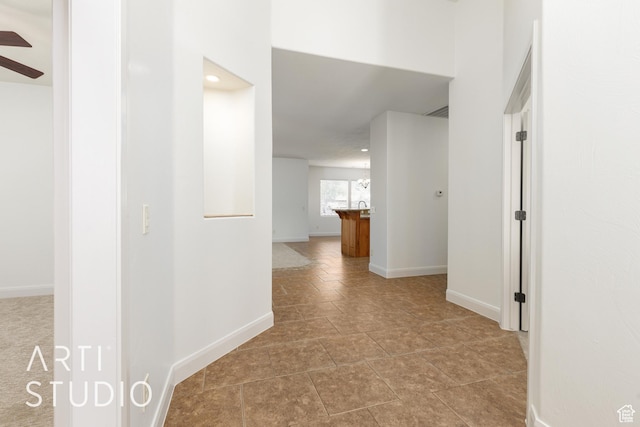 hallway featuring recessed lighting and baseboards
