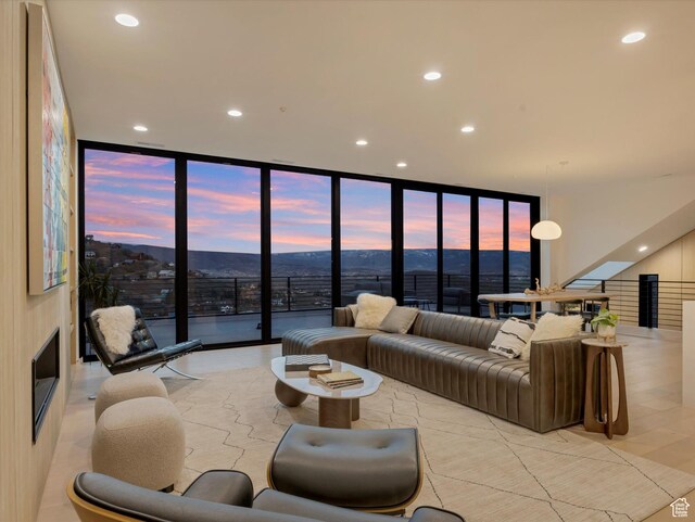 living room with a wall of windows, recessed lighting, and healthy amount of natural light