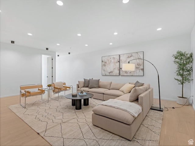 living room featuring recessed lighting, light wood finished floors, and baseboards