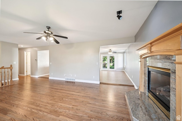 3391 E Brockbank Dr S, Millcreek, UT 84124 - unfurnished living room with ceiling fan, wood finished floors, a fireplace, and baseboards