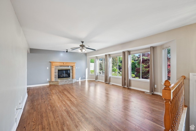 3391 E Brockbank Dr S, Millcreek, UT 84124 - unfurnished living room with ceiling fan, wood finished floors, baseboards, and a glass covered fireplace