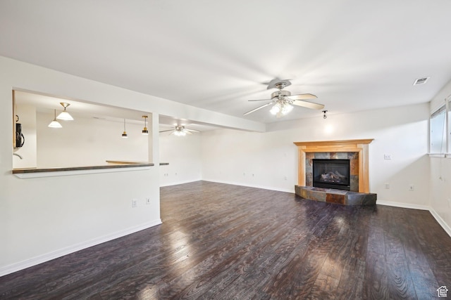 3391 E Brockbank Dr S, Millcreek, UT 84124 - unfurnished living room with a ceiling fan, a tile fireplace, wood finished floors, and baseboards