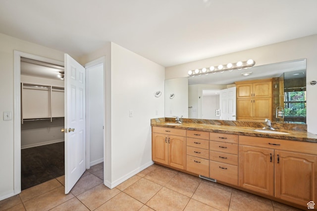 3391 E Brockbank Dr S, Millcreek, UT 84124 - bathroom featuring double vanity, a walk in closet, tile patterned flooring, baseboards, and an enclosed shower