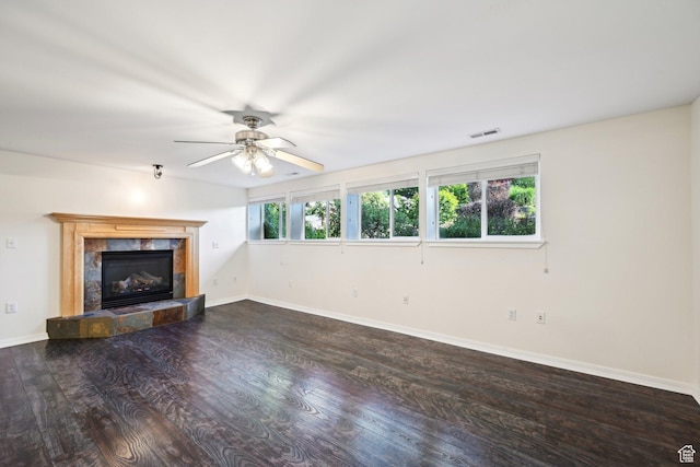 3391 E Brockbank Dr S, Millcreek, UT 84124 - unfurnished living room featuring wood finished floors, a tiled fireplace, ceiling fan, and baseboards