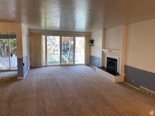 2547 E 1900 N, Layton, UT 84040 - unfurnished living room with carpet flooring, visible vents, and a brick fireplace