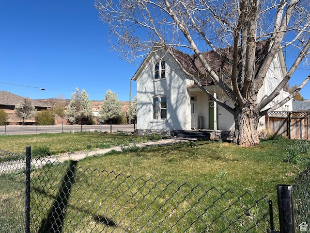 exterior space with a yard, covered porch, and fence