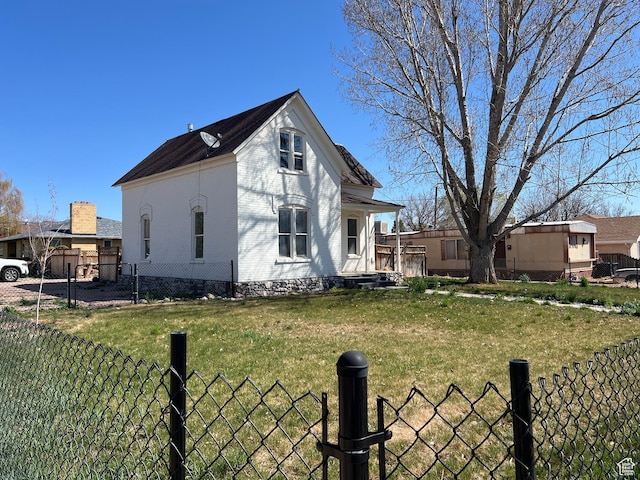 view of home's exterior featuring brick siding, fence, and a lawn