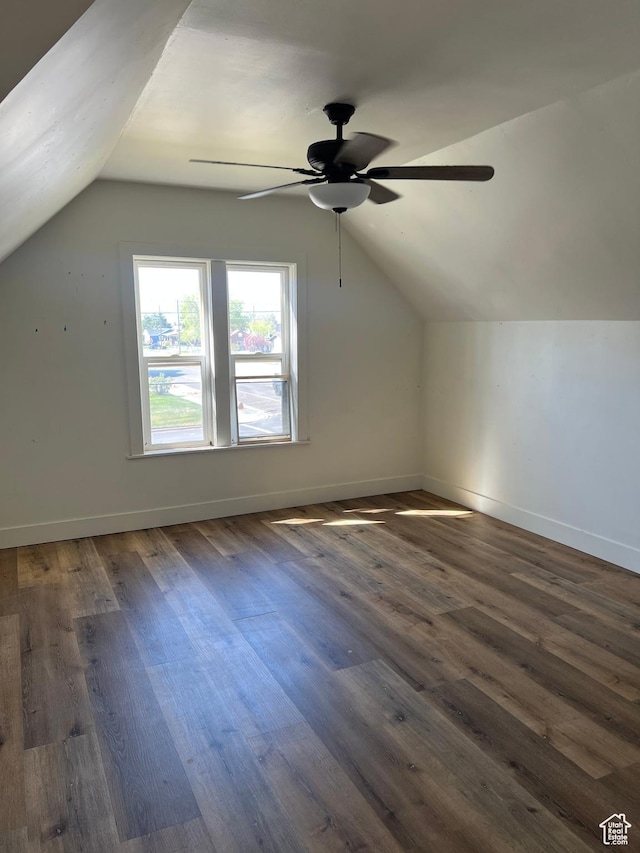 additional living space featuring ceiling fan, dark wood-style floors, and lofted ceiling