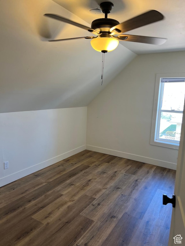 bonus room with dark wood-type flooring, ceiling fan, baseboards, and lofted ceiling