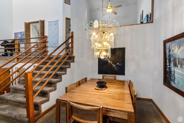 4042 Saddleback Rd, Park City, UT 84098 - dining room featuring ceiling fan with notable chandelier, a towering ceiling, carpet flooring, stairs, and baseboards