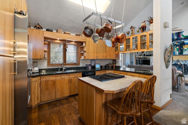 4042 Saddleback Rd, Park City, UT 84098 - kitchen featuring a kitchen bar, open shelves, black appliances, a sink, and butcher block countertops