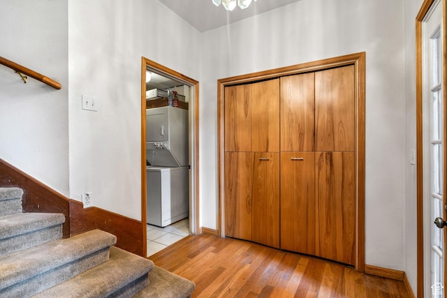 4042 Saddleback Rd, Park City, UT 84098 - foyer with stacked washer and dryer, light wood finished floors, baseboards, and stairway