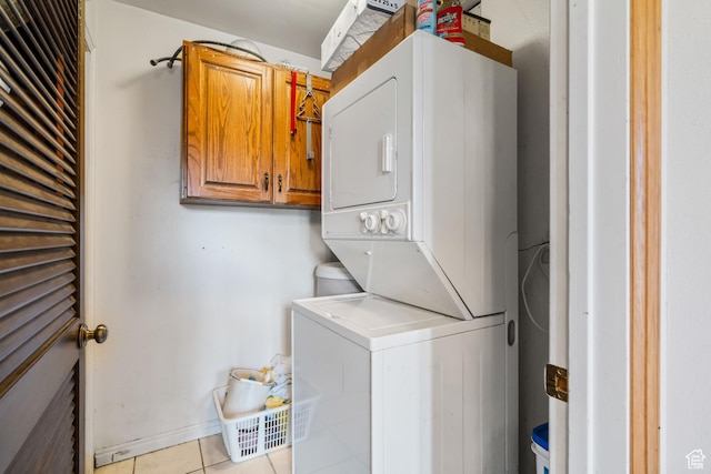 4042 Saddleback Rd, Park City, UT 84098 - washroom with stacked washing maching and dryer, light tile patterned floors, and cabinet space