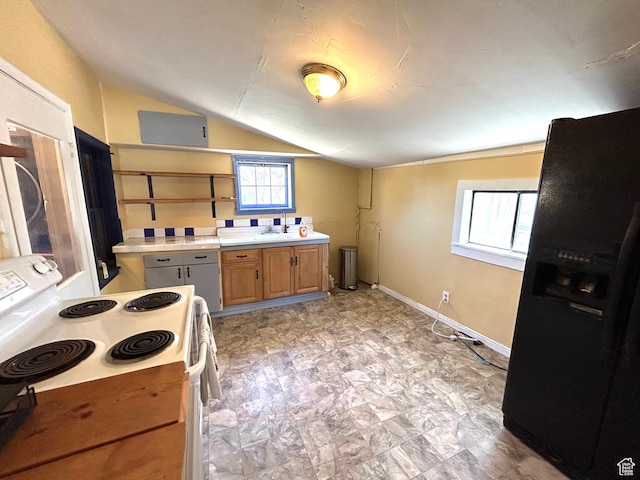 30028 Old Lincoln Hwy, Wanship, UT 84017 - kitchen with vaulted ceiling, light countertops, open shelves, black fridge with ice dispenser, and white electric range