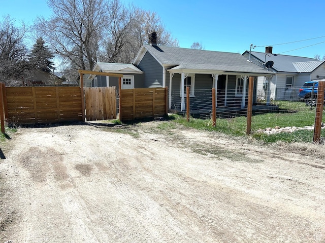 30028 Old Lincoln Hwy, Wanship, UT 84017 - view of home's exterior with a chimney, covered porch, and fence