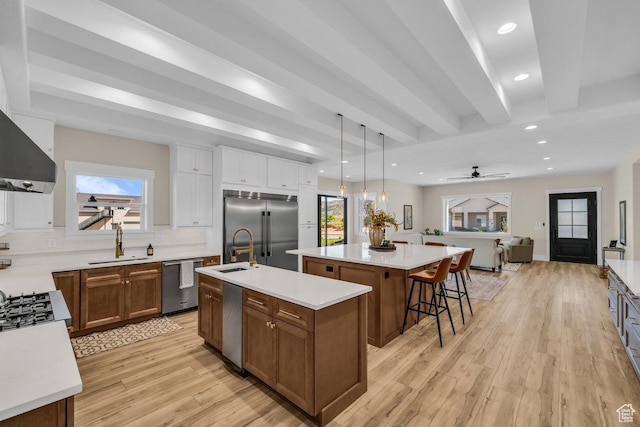 1816 S 920 W, Hurricane, UT 84737 - kitchen with a sink, light countertops, stainless steel appliances, a large island with sink, and light wood-style flooring
