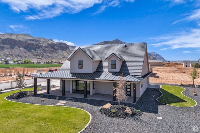 1816 S 920 W, Hurricane, UT 84737 - rear view of property featuring stucco siding, a mountain view, a patio area, a standing seam roof, and metal roof